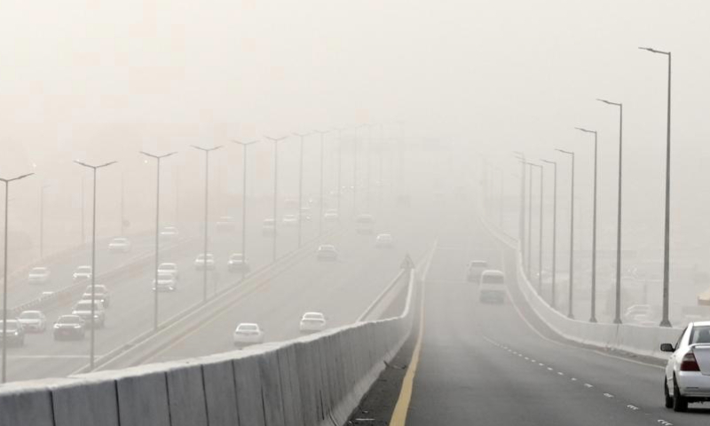 Vehicles run on the road during a dust storm in Farwaniya Governorate, Kuwait, Dec. 15, 2024. (Photo by Asad/Xinhua)