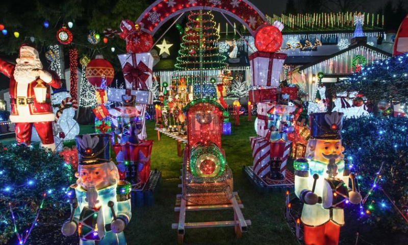 Christmas lights and decorations are seen in the front yard of a residential house in Vancouver, British Columbia, Canada, Dec. 22, 2024. (Photo by Liang Sen/Xinhua)