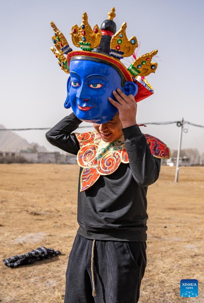 A craftsman checks a traditional Tibetan mask in Dagze District of Lhasa, southwest China's Xizang Autonomous Region, Dec. 9, 2024.(Photo: Xinhua)