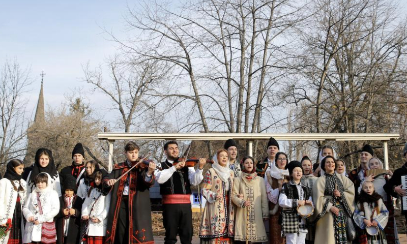 Members of a traditional band perform during the White Flowers festival of traditions and customs in Bucharest, Romania, on Dec. 14, 2024. (Photo by Cristian Cristel/Xinhua)