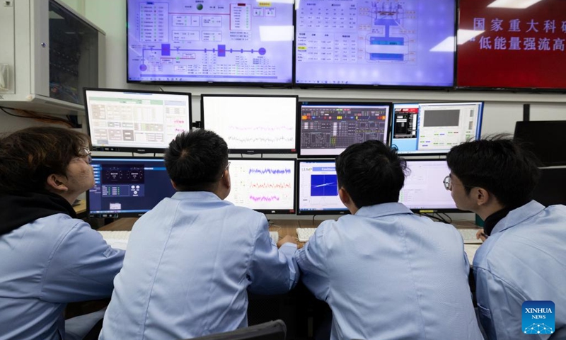 Researchers observe experiment progress at the control room of the low-energy high-intensity heavy-ion accelerator facility (LEAF) on Dec. 10, 2024. (Photo: Xinhua)