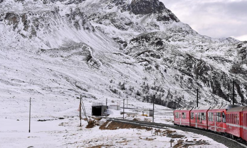 A train runs on the Albula-Bernina railway in Switzerland, Dec. 3, 2024. As a UNESCO World Heritage Site since 2008, the Albula-Bernina railway, one-third of the century-old Rhaetian Railway (RhB), spans 122 km from Thusis, Switzerland, to Tirano, Italy, traversing 196 bridges, 55 tunnels, and 20 towns across alpine landscapes. (Xinhua/Lian Yi)