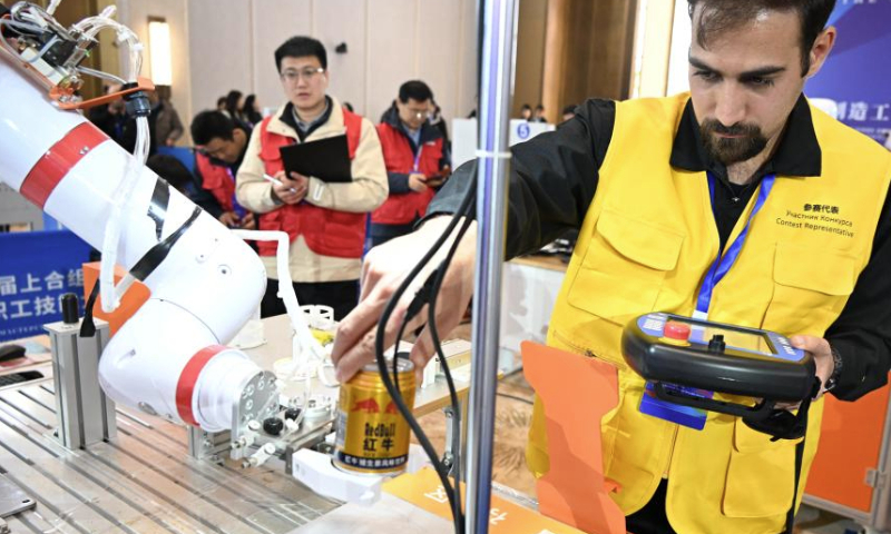 Mohammadjavad Haghi from Iran competes in the third SCO Countries Worker Skills Contest in Qingdao, east China's Shandong Province, Dec. 18, 2024. The contest kicked off on Wednesday in Qingdao, attracting skilled workers competing in three programs. (Xinhua/Li Ziheng)