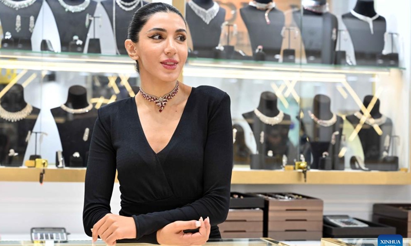 A woman displays jewelry at the International Gold and Jewelry Exhibition in Hawalli Governorate, Kuwait, on Dec. 11, 2024. The International Gold and Jewelry Exhibition kicked off here on Wednesday and will last until Dec. 16 with the participation of more than 200 exhibitors. (Photo: Xinhua)