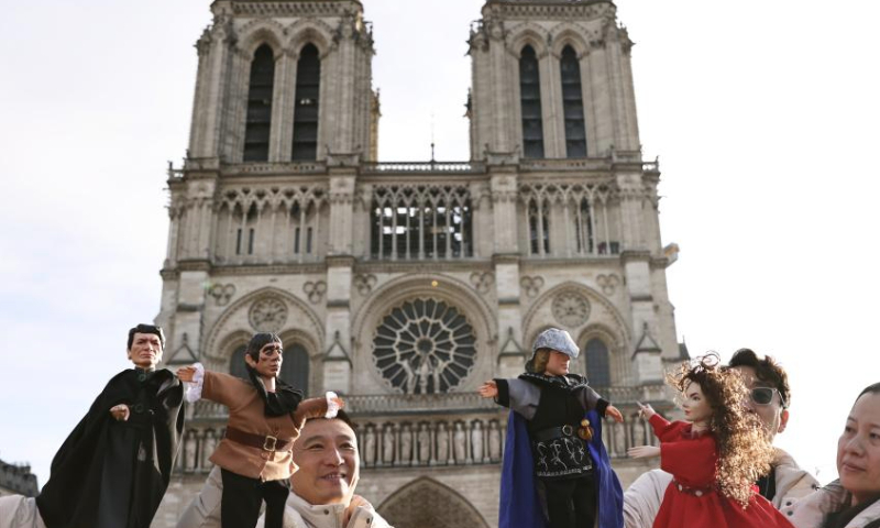 Chinese actors perform a hand-puppet theater play Notre-Dame de Paris in front of the Notre-Dame de Paris cathedral, in Paris, France, Dec. 15, 2024. Chinese actors staged a flash mob performance of hand-puppet theater play Notre-Dame de Paris in front of the newly reopened Notre-Dame de Paris cathedral, as part of the Chinese Tour in France's Most Beautiful Villages, an event designed to boost Franco-Chinese cultural exchanges. (Xinhua/Gao Jing)