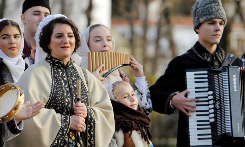 Members of a traditional band perform during the White Flowers festival of traditions and customs in Bucharest, Romania, on Dec. 14, 2024. (Photo by Cristian Cristel/Xinhua)