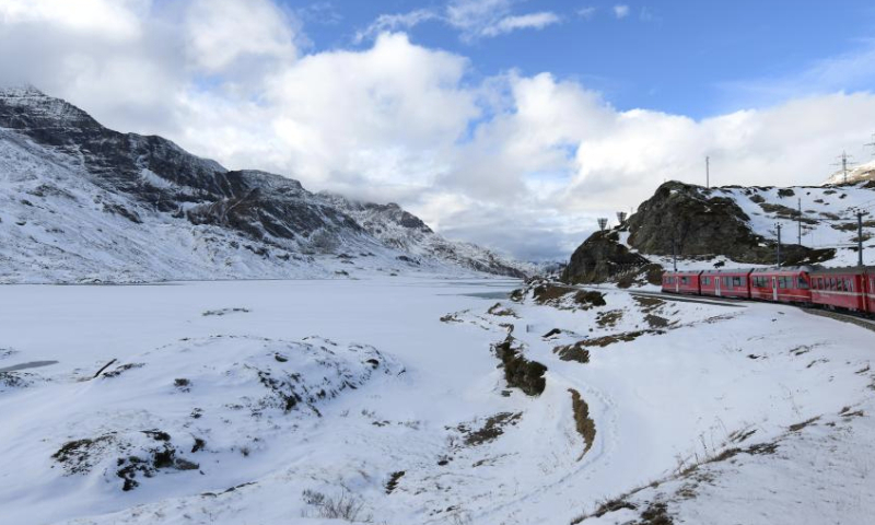 A train runs on the Albula-Bernina railway in Switzerland, Dec. 3, 2024. As a UNESCO World Heritage Site since 2008, the Albula-Bernina railway, one-third of the century-old Rhaetian Railway (RhB), spans 122 km from Thusis, Switzerland, to Tirano, Italy, traversing 196 bridges, 55 tunnels, and 20 towns across alpine landscapes. (Xinhua/Lian Yi)