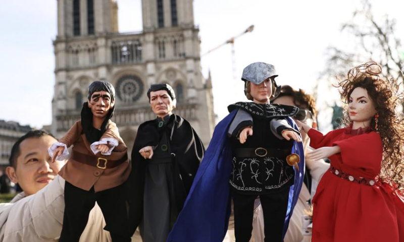 Chinese actors perform a hand-puppet theater play Notre-Dame de Paris in front of the Notre-Dame de Paris cathedral, in Paris, France, Dec. 15, 2024. Chinese actors staged a flash mob performance of hand-puppet theater play Notre-Dame de Paris in front of the newly reopened Notre-Dame de Paris cathedral, as part of the Chinese Tour in France's Most Beautiful Villages, an event designed to boost Franco-Chinese cultural exchanges. (Xinhua/Gao Jing)