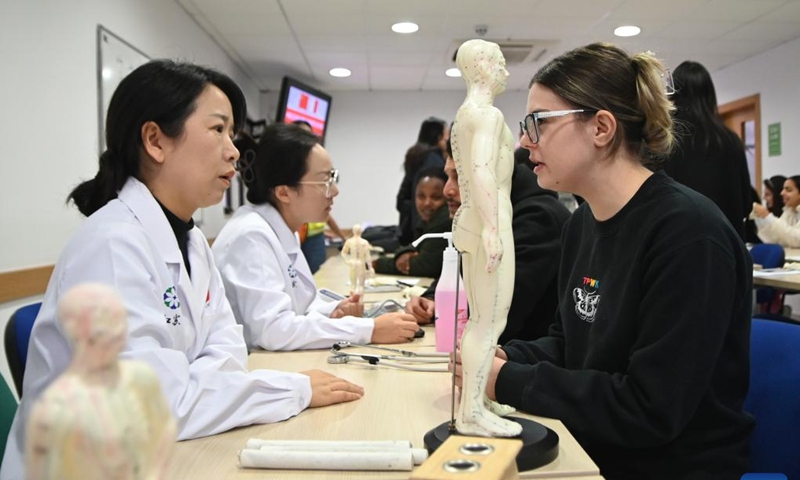 Members of the 20th Chinese medical team for Malta offer free health consultations and clinical services to students at the University of Malta in Msida, Malta, on Dec. 11, 2024. Maltese students have been discovering traditional Chinese medicine (TCM) and the Chinese language this week, in a unique cultural experience organized by the Confucius Institute at the University of Malta. (Photo: Xinhua)