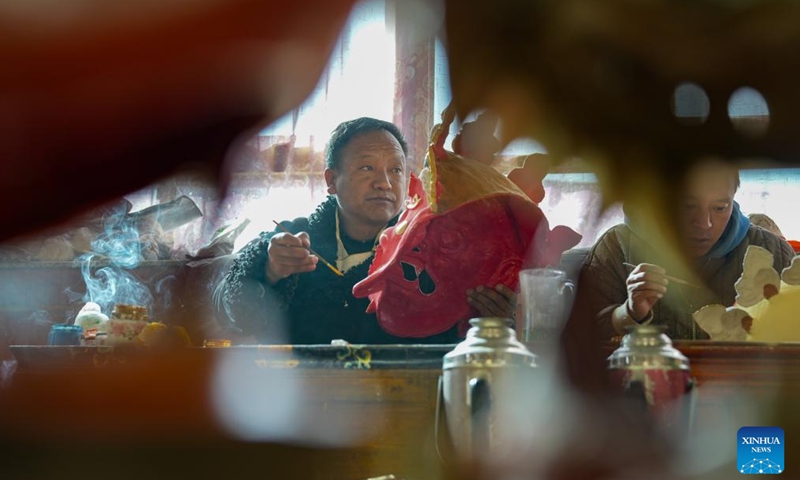 Shilok crafts a traditional Tibetan mask at a cooperative in Dagze District of Lhasa, southwest China's Xizang Autonomous Region, Dec. 9, 2024. (Photo: Xinhua)