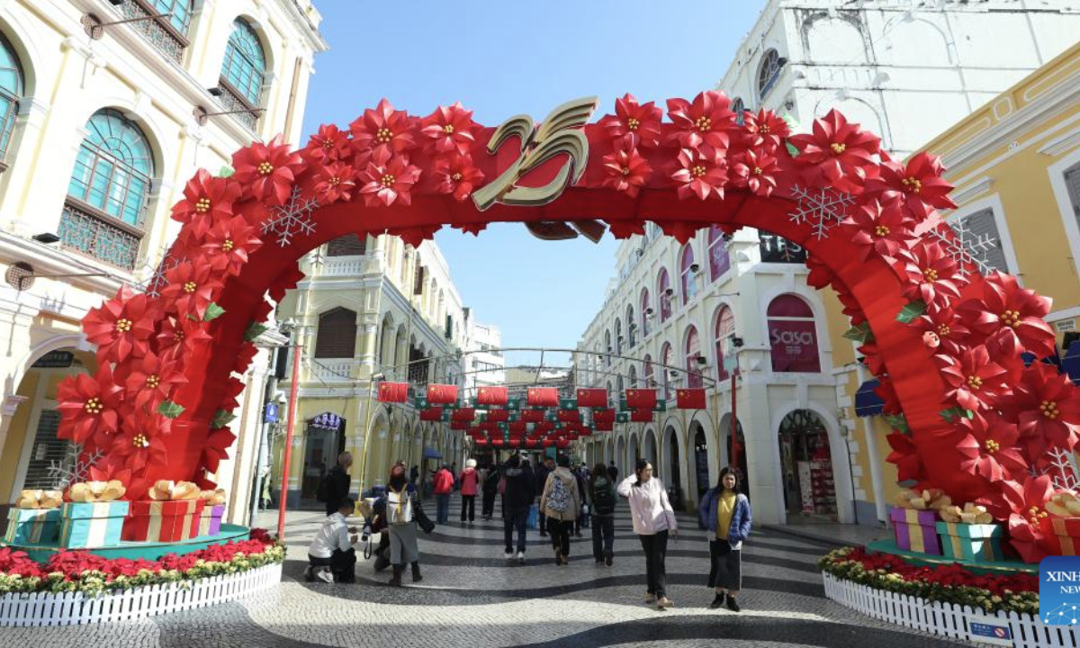 People visit a tourist attraction in Macao, south China, Dec. 17, 2024. The streets of Macao have been adorned by festive decorations, as the city is set to mark the 25th anniversary of its return to the motherland. (Xinhua/Yao Qilin)