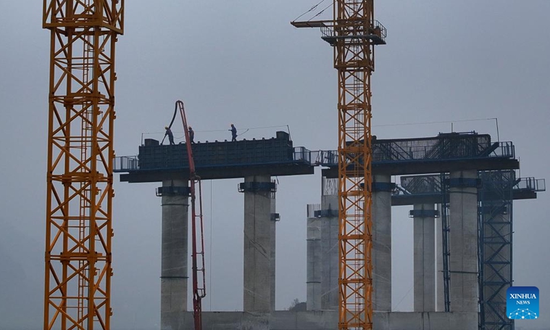 An aerial drone photo shows people working at the construction site of an expressway linking Yufeng and Yizhou in south China's Guangxi Zhuang Autonomous Region, Dec. 11, 2024. (Photo: Xinhua)