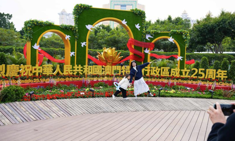 People visit a flower show on Taipa Island in Macao, south China, Dec. 14, 2024. A flower show celebrating the 25th anniversary of Macao's return to the motherland kicked off here on Saturday, and will run until Jan. 5, 2025. (Xinhua/Cheong Kam Ka)