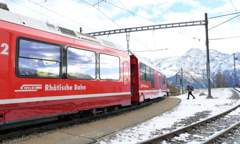 A train stops at a station along the Albula-Bernina railway in Switzerland, Dec. 3, 2024. As a UNESCO World Heritage Site since 2008, the Albula-Bernina railway, one-third of the century-old Rhaetian Railway (RhB), spans 122 km from Thusis, Switzerland, to Tirano, Italy, traversing 196 bridges, 55 tunnels, and 20 towns across alpine landscapes. (Xinhua/Lian Yi)