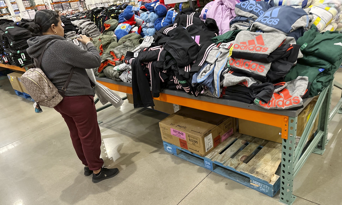 A shopper looks over clothing on display in a Costco warehouse Wednesday, Dec. 4, 2024, in Sheridan, Colorado, US. Photo: VCG