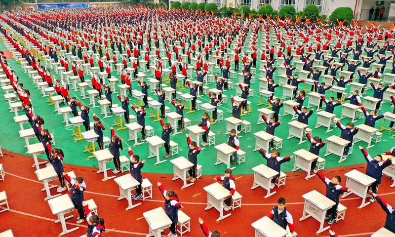 Elementary school students from Southwest China's Chongqing Municipality participate in a gymnastics competition in an outdoor playground after moving their desks and chairs outside, on December 11, 2024. Photo: VCG