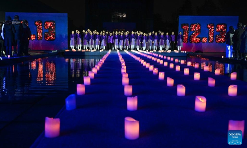 Children sing a song while attending a candle light vigil at the Memorial Hall of the Victims in Nanjing Massacre by Japanese Invaders in Nanjing, capital of east China's Jiangsu Province, Dec. 13, 2024. A candle light vigil was held here on Friday to mark this year's national memorial day for the victims of the Nanjing Massacre. (Photo: Xinhua)