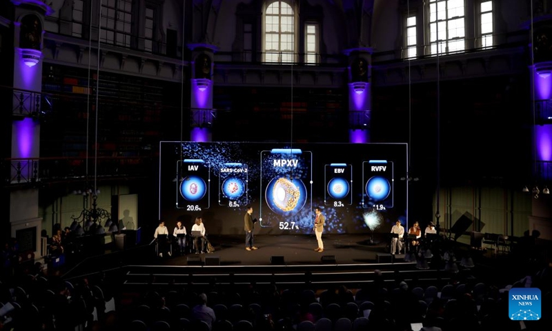 People participate in a demonstration of smart education showcasing a scenario of a future computational biology class using AI, digital twin and virtual reality (VR) technologies, during an international conference on online education and massive open online courses (MOOC) in London, Britain, on Dec. 12, 2024.  (Photo: Xinhua)