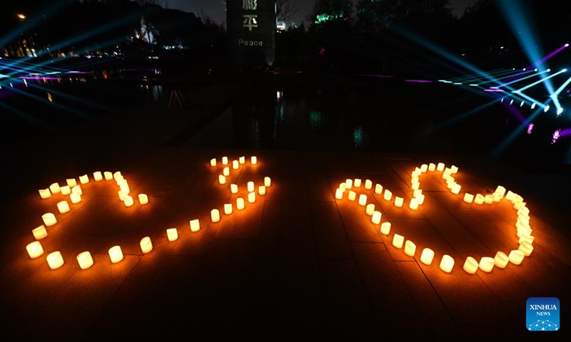 This photo taken on Dec. 13, 2024 shows a candle light vigil at the Memorial Hall of the Victims in Nanjing Massacre by Japanese Invaders in Nanjing, capital of east China's Jiangsu Province. A candle light vigil was held here on Friday to mark this year's national memorial day for the victims of the Nanjing Massacre. (Photo: Xinhua)