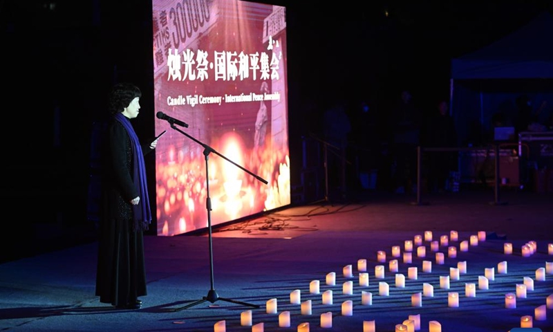 This photo taken on Dec. 13, 2024 shows a candle light vigil at the Memorial Hall of the Victims in Nanjing Massacre by Japanese Invaders in Nanjing, capital of east China's Jiangsu Province. A candle light vigil was held here on Friday to mark this year's national memorial day for the victims of the Nanjing Massacre. (Photo: Xinhua)