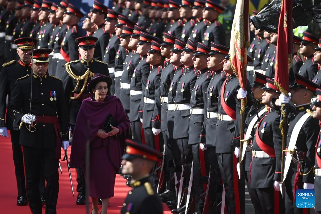 Maltese President Myriam Spiteri Debono inspects the guard of honor during a ceremonial parade by the Armed Forces of Malta in celebration of the 50th anniversary of the Republic of Malta in Valletta, Malta, on Dec. 13, 2024. (Photo: Xinhua)