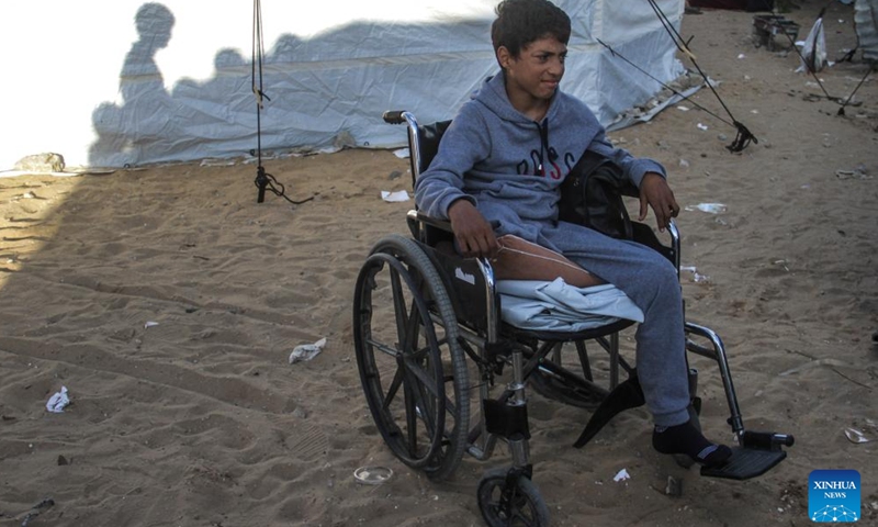 Akram Harb sits in a wheelchair in Gaza City, on Dec. 13, 2024. Harb, a 13-year-old Palestinian, was injured in an Israeli attack at his house in the Jabalia refugee camp in the northern Gaza Strip in October, 2024. (Photo: Xinhua)