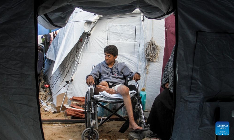 Akram Harb sits in a wheelchair in Gaza City, on Dec. 13, 2024. Harb, a 13-year-old Palestinian, was injured in an Israeli attack at his house in the Jabalia refugee camp in the northern Gaza Strip in October, 2024. (Photo: Xinhua)