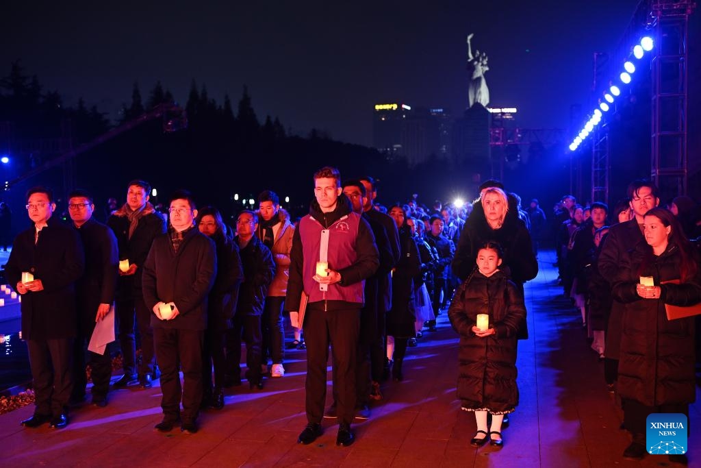 People attend a candle light vigil at the Memorial Hall of the Victims in Nanjing Massacre by Japanese Invaders in Nanjing, capital of east China's Jiangsu Province, Dec. 13, 2024. A candle light vigil was held here on Friday to mark this year's national memorial day for the victims of the Nanjing Massacre. (Photo: Xinhua)