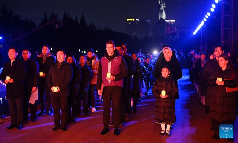 People attend a candle light vigil at the Memorial Hall of the Victims in Nanjing Massacre by Japanese Invaders in Nanjing, capital of east China's Jiangsu Province, Dec. 13, 2024. (Photo: Xinhua)