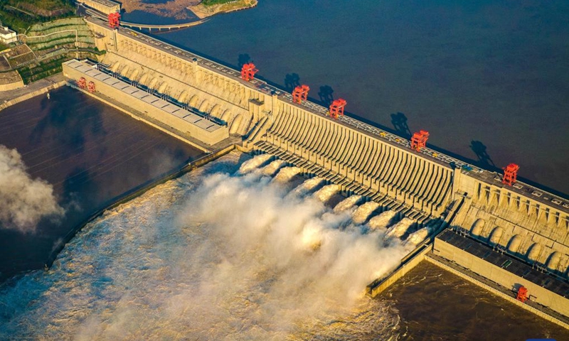 An aerial drone photo taken on Aug. 19, 2020 shows water gushing out from the Three Gorges Dam in central China's Hubei Province. The Three Gorges project, the world's largest hydropower project, has generated over 1.7 trillion kWh of electricity. It marked the 30th anniversary of its construction on Saturday.