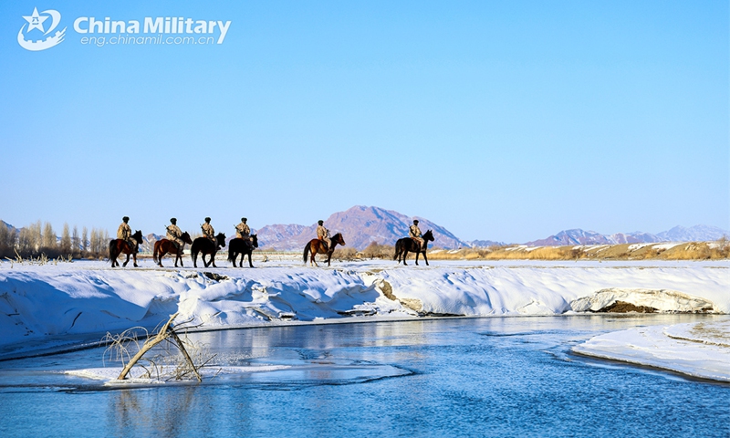 Soldiers attached to the Takixken border defense company under the Chinese PLA Xinjiang Military Command carefully steer their horses to pass through snowfield during a routine patrol mission on November 29, 2024. (eng.chinamil.com.cn/Photo by Xiao Guotao)