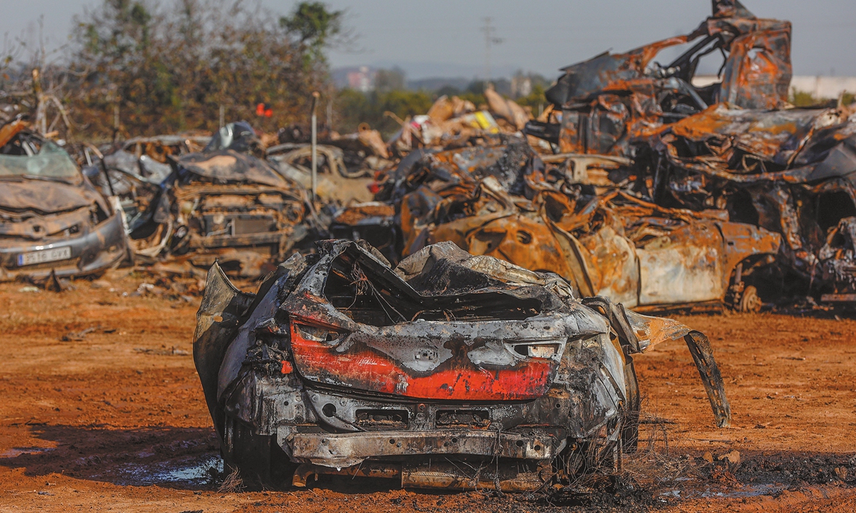 Burned-out cars are piled up after a fire broke out  at a waste and vehicle storage area on December 17, 2024, in Catarroja, Valencia, Spain. The site contains vehicles and other waste recovered in the aftermath of Storm Dana which devastated large parts of eastern Spain on October 29, 2024. Firefighters extinguished the blaze at midnight. Photo: VCG