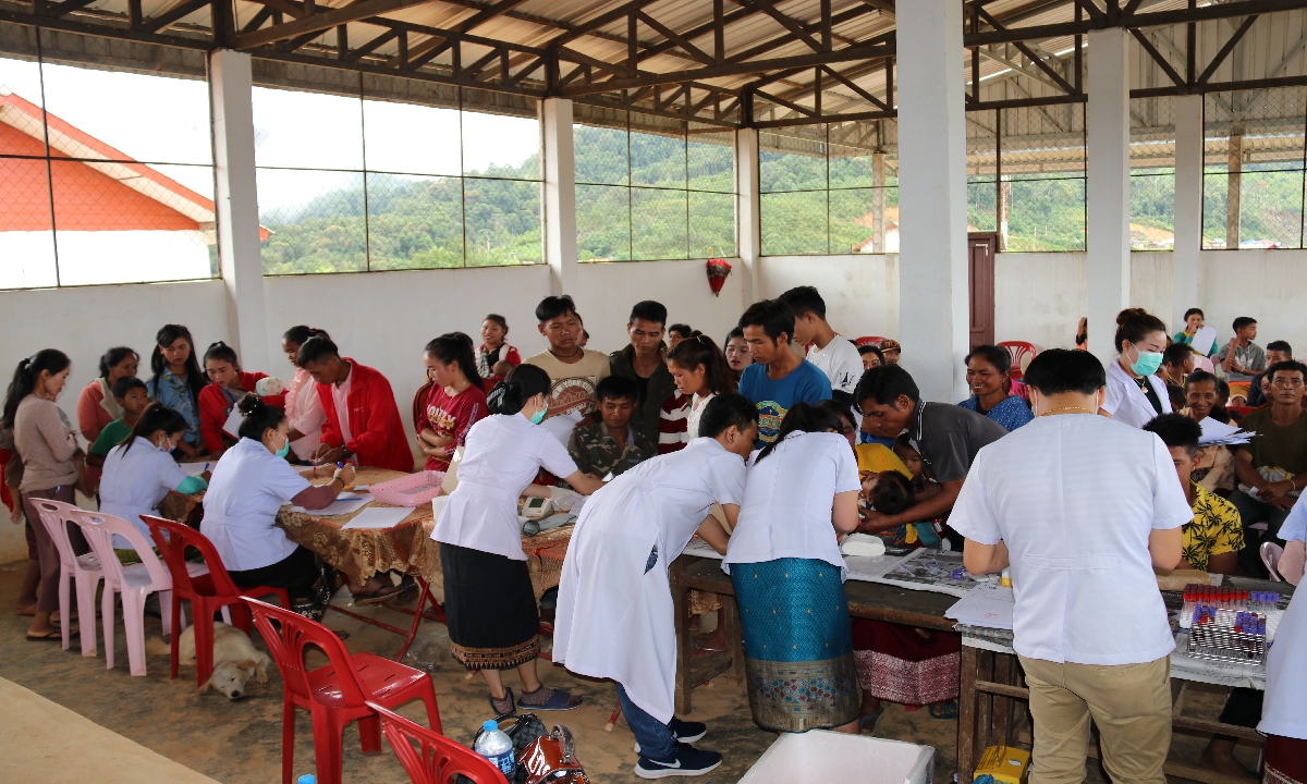 The?employees of the Nam Phay hydropower plant conduct health check-ups for the residents of  the newly established village in 2020. Photo: Courtesy of Norinco International