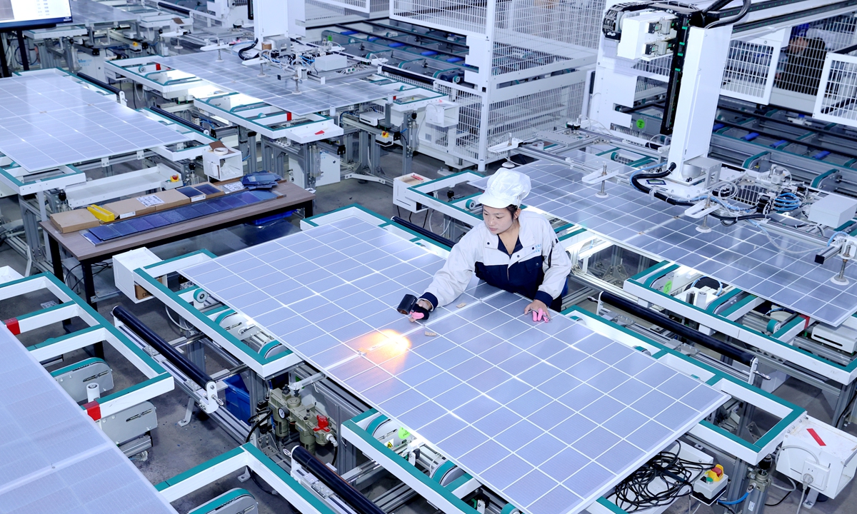 A worker manufactures photovoltaic panels at a workshop in Suqian, East China's Jiangsu Province on December 17, 2024. In the first three quarters of 2024, China's exports of the 