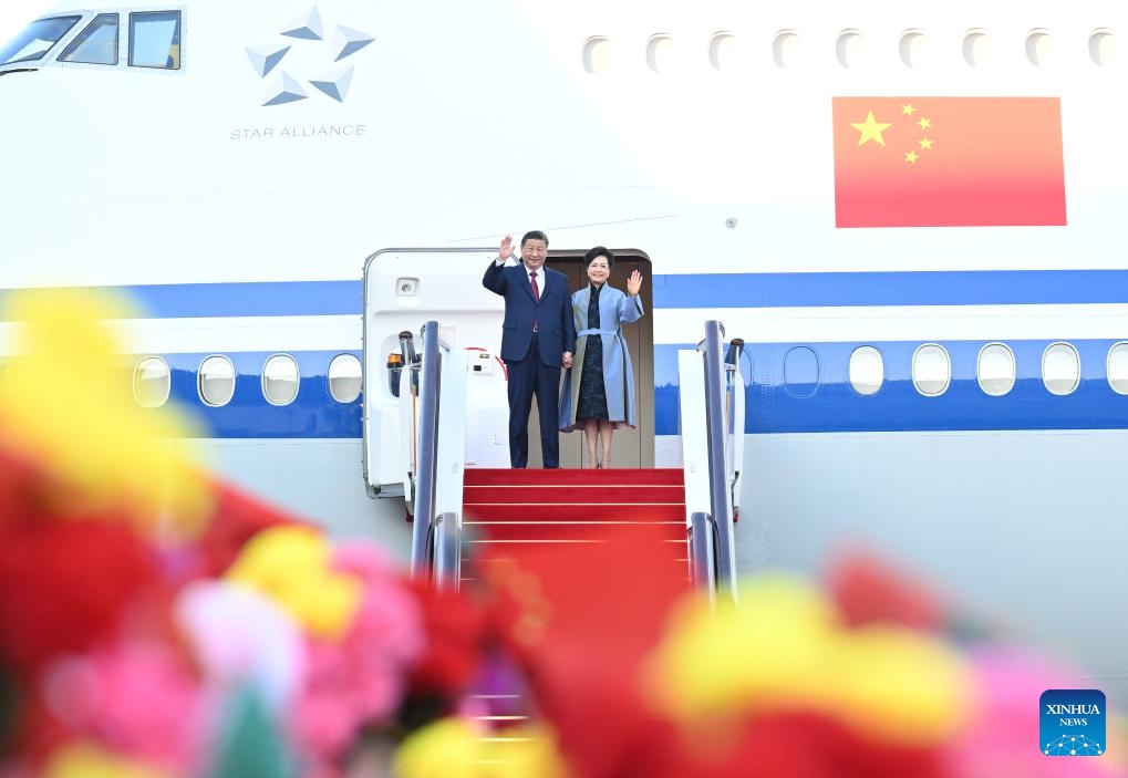 Chinese President Xi Jinping, also general secretary of the Communist Party of China Central Committee and chairman of the Central Military Commission, and his wife Peng Liyuan step out of the plane and greet the welcoming crowd in Macao, south China, Dec. 18, 2024. (Photo: Xinhua)