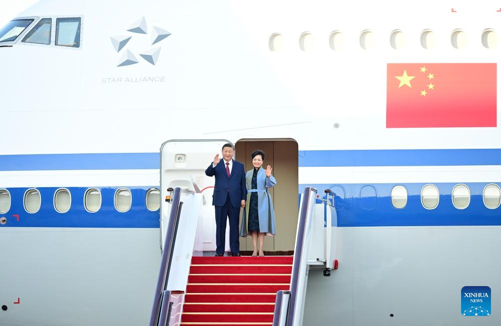 Chinese President Xi Jinping, also general secretary of the Communist Party of China Central Committee and chairman of the Central Military Commission, and his wife Peng Liyuan step out of the plane and greet the welcoming crowd in Macao, south China, Dec. 18, 2024. (Photo: Xinhua)