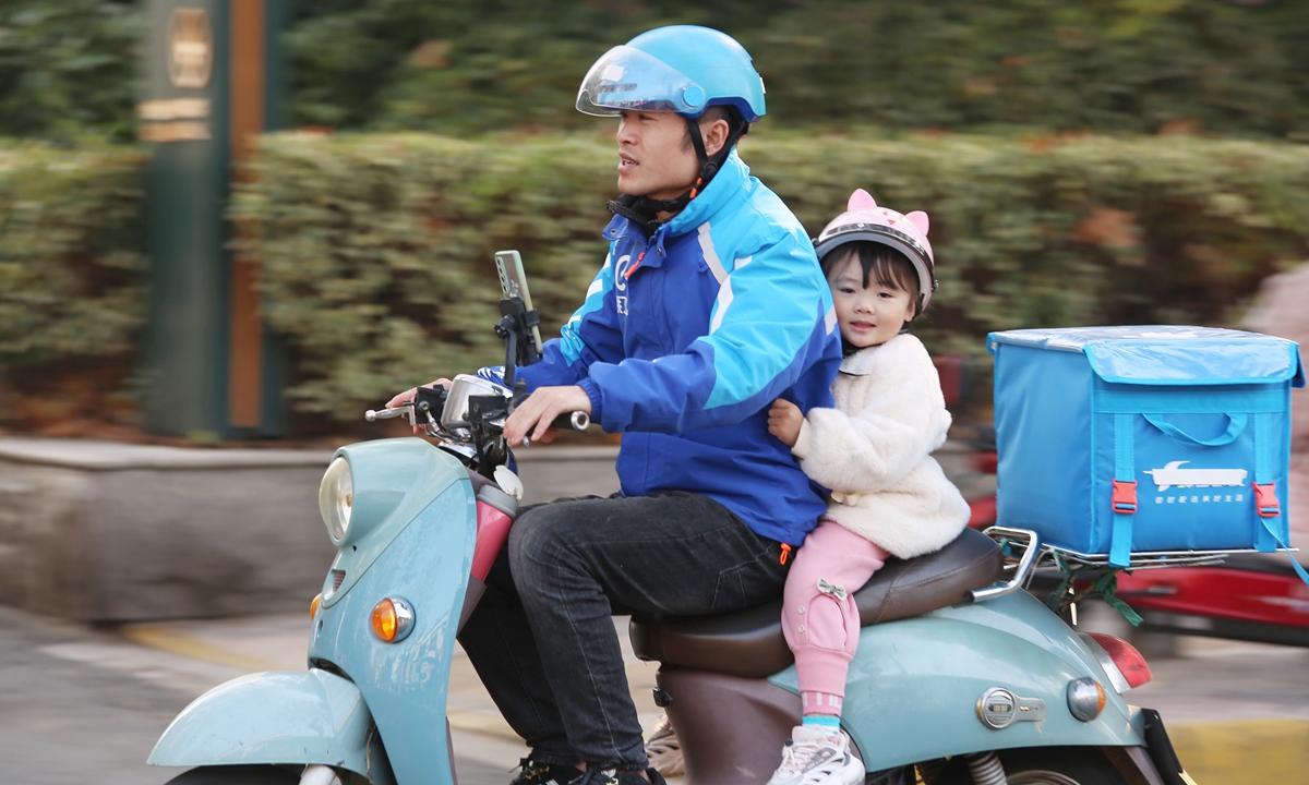 
Baby girl Li Fei'er accompanies her father on food deliveries in Changzhou, Jiangsu Province, on December 6, 2021. Photo: VCG
