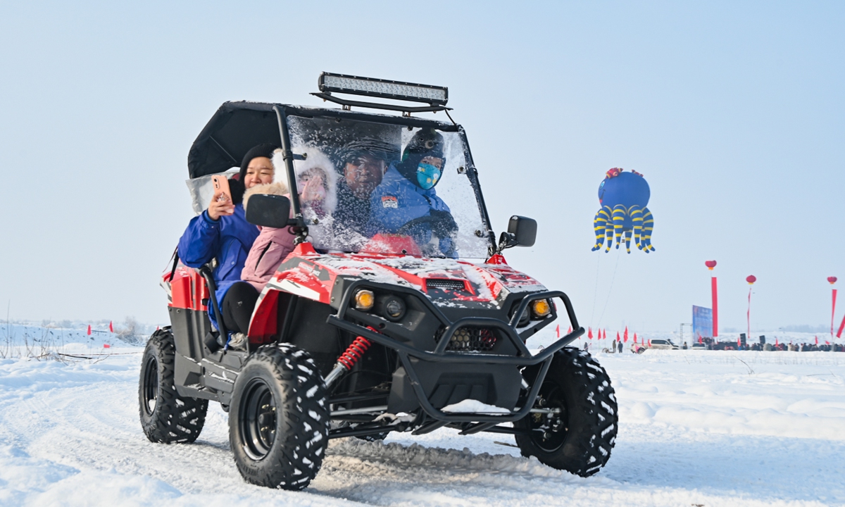 Tourists experience snowmobiles in Hutubi county, Northwest China's Xinjiang Uygur Autonomous Region. Photo: VCG