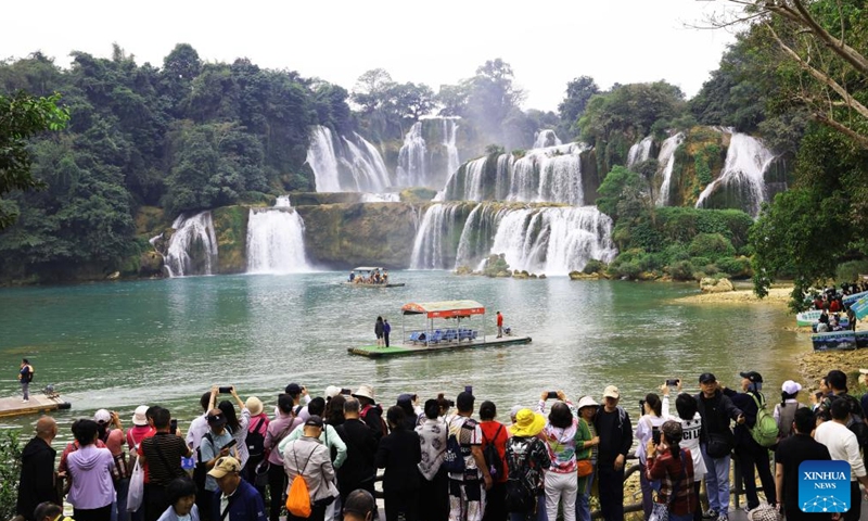 Tourists visit the Chinese part of the China-Vietnam Detian-Ban Gioc Waterfall cross-border tourism cooperation zone in Chongzuo, south China's Guangxi Province, Dec. 5, 2024. (Xinhua/Jin Haoyuan)