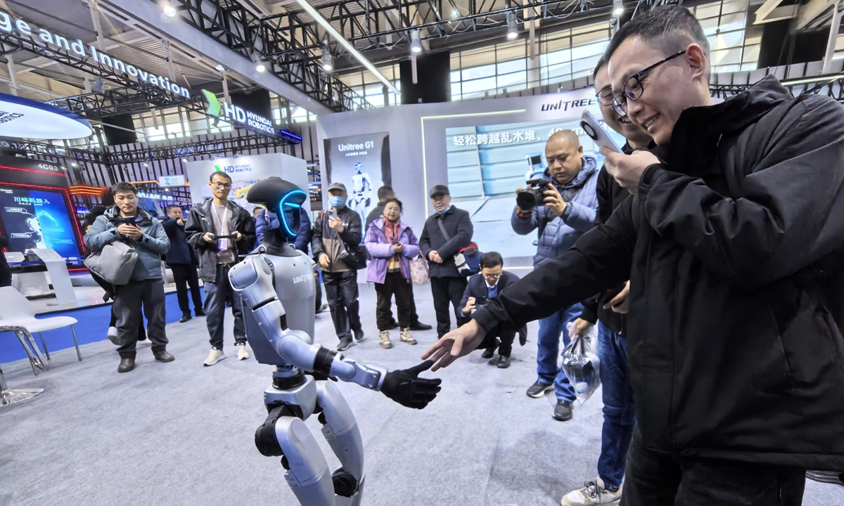 A visitor interacts with a robot during the 2024 World Intelligent Manufacturing Conference, which opened at the Nanjing International Expo Center, East China’s Jiangsu Province on December 20, 2024. Photo: VCG

