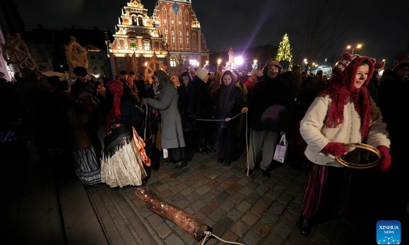 People pull a block in Riga, Latvia, Dec. 19, 2024.The traditional block-pulling event took place here on Thursday, which symbolically removes the old and gives way to the new year. (Photo by Edijs Palens/Xinhua)