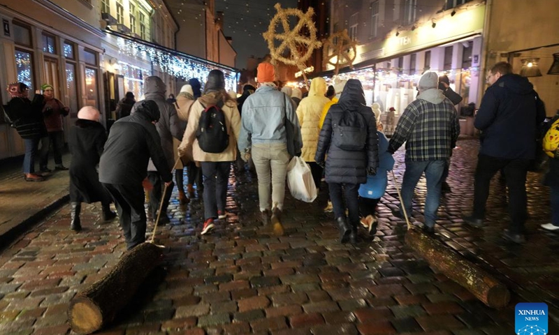 People pull blocks in Riga, Latvia, Dec. 19, 2024.The traditional block-pulling event took place here on Thursday, which symbolically removes the old and gives way to the new year. (Photo by Edijs Palens/Xinhua)