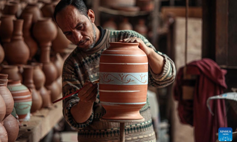 An artisan colors a pottery at a workshop at the village of Gris, Menoufia Governorate, Egypt, on Dec. 7, 2024.(Xinhua/Ahmed Gomaa)