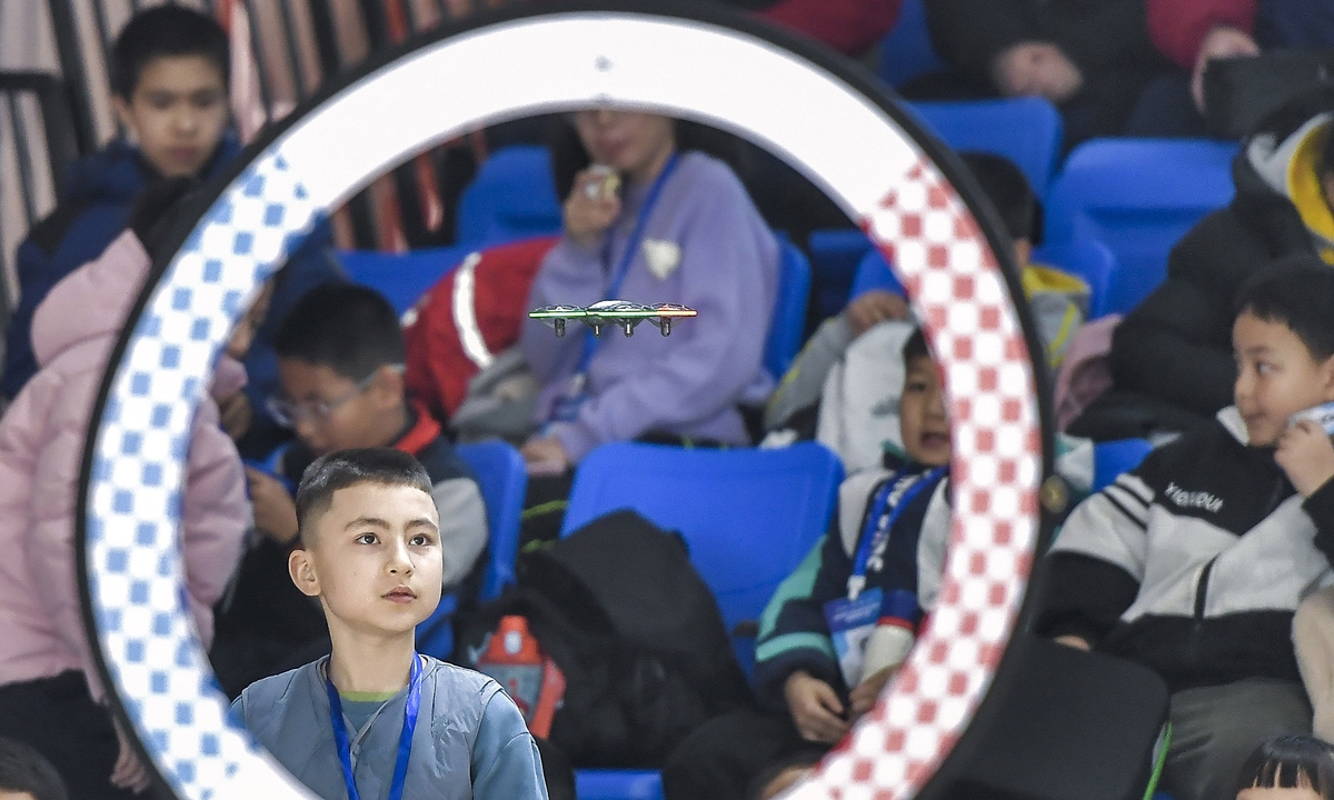 
A student navigates a drone flying through obstacles in a science and technology innovation competition held in Urumqi, Northwest China's Xinjiang Uygur Autonomous Region on December 22, 2024. The competition has several categories, including 3D creative design and aerospace model education, drawing the participation of more than 6,000 primary and secondary school students, chinanews.com.cn reported. 