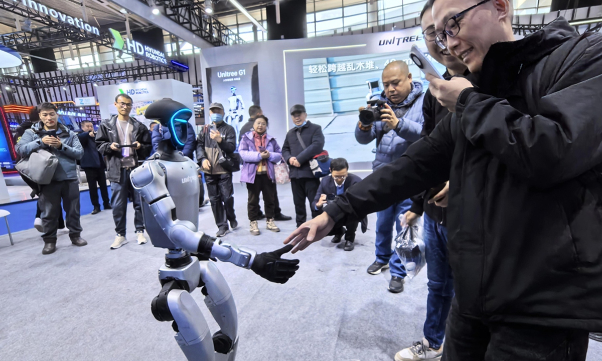 A visitor interacts with a robot during the 2024 World Intelligent Manufacturing Conference, which opened at the Nanjing International Expo Center, East China's Jiangsu Province on December 20, 2024. Photo: VCG