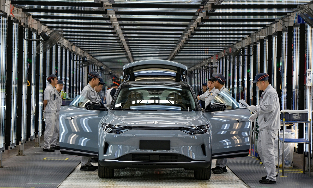 Workers complete assembling an electric vehicle (EV) at China's EV start-up Leapmotor in Jinhua, East China's Zhejiang Province on April 1, 2024. The smart EV factory delivered 14,567 new vehicles in March, a yearly increase of 136 percent. Photo: VCG