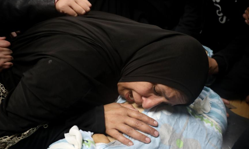 People mourn a Palestinian man killed by Israeli army gunfire at a hospital in the West Bank city of Nablus, on Jan. 4, 2025. A Palestinian was killed and eight others injured, including one critically, by Israeli army gunfire in a refugee camp in the northern West Bank city of Nablus on Friday, Palestinian authorities said. (Photo by Ayman Nobani/Xinhua)