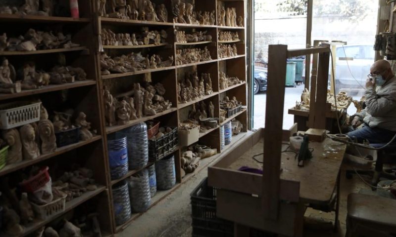 A craftsman is seen at a workshop in the West Bank city of Bethlehem, Dec. 23, 2024. Revered as the site of Jesus Christ's birth, Bethlehem sees a muted Christmas season this year as tourists stay away amid the Israeli ongoing attacks on the Gaza Strip. (Photo by Mamoun Wazwaz/Xinhua)