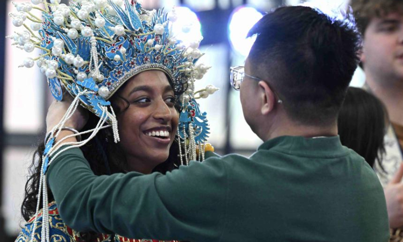 A U.S. college student tries a set of Peking Opera costumes in Shijiazhuang, north China's Hebei Province, Dec. 30, 2024. At the invitation of Shijiazhuang Foreign Language School, a group of U.S. teachers and students visit Shijiazhuang from Dec. 25 to Dec. 31. (Photo by Chen Qibao/Xinhua)