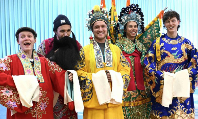 U.S. college students pose for photos in Peking Opera costumes in Shijiazhuang, north China's Hebei Province, Dec. 30, 2024. At the invitation of Shijiazhuang Foreign Language School, a group of U.S. teachers and students visit Shijiazhuang from Dec. 25 to Dec. 31. (Photo by Chen Qibao/Xinhua)